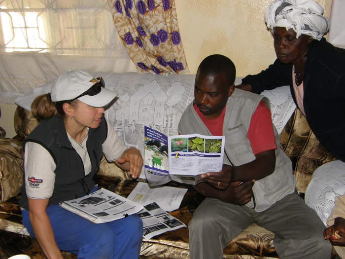 Photo of Kami Swanson counselling several local farmers