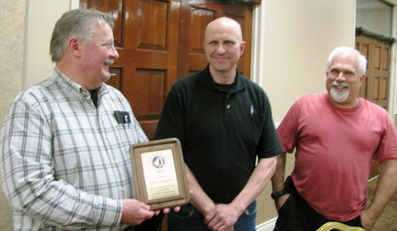 Gary Paynter receiving a commemorative plaque of thanks