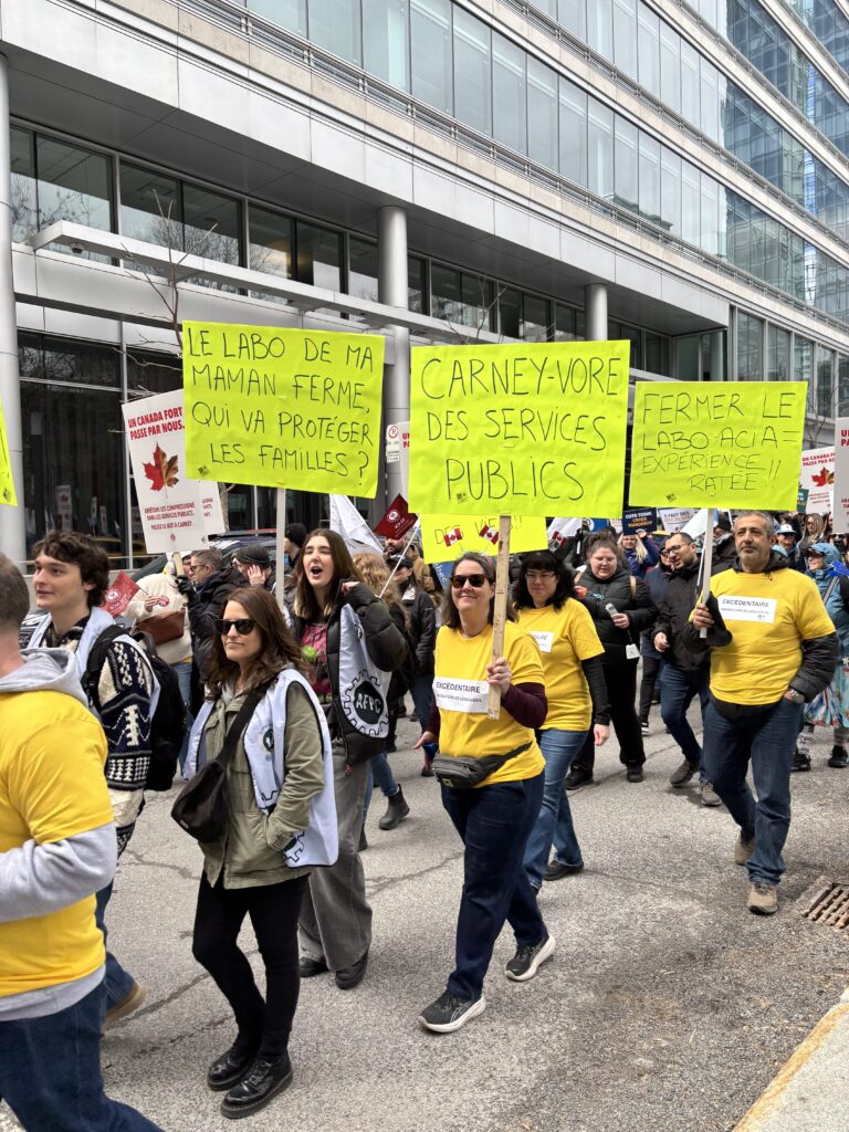 Union members of the Longueuil CFIA lab marching with placards in a demonstration